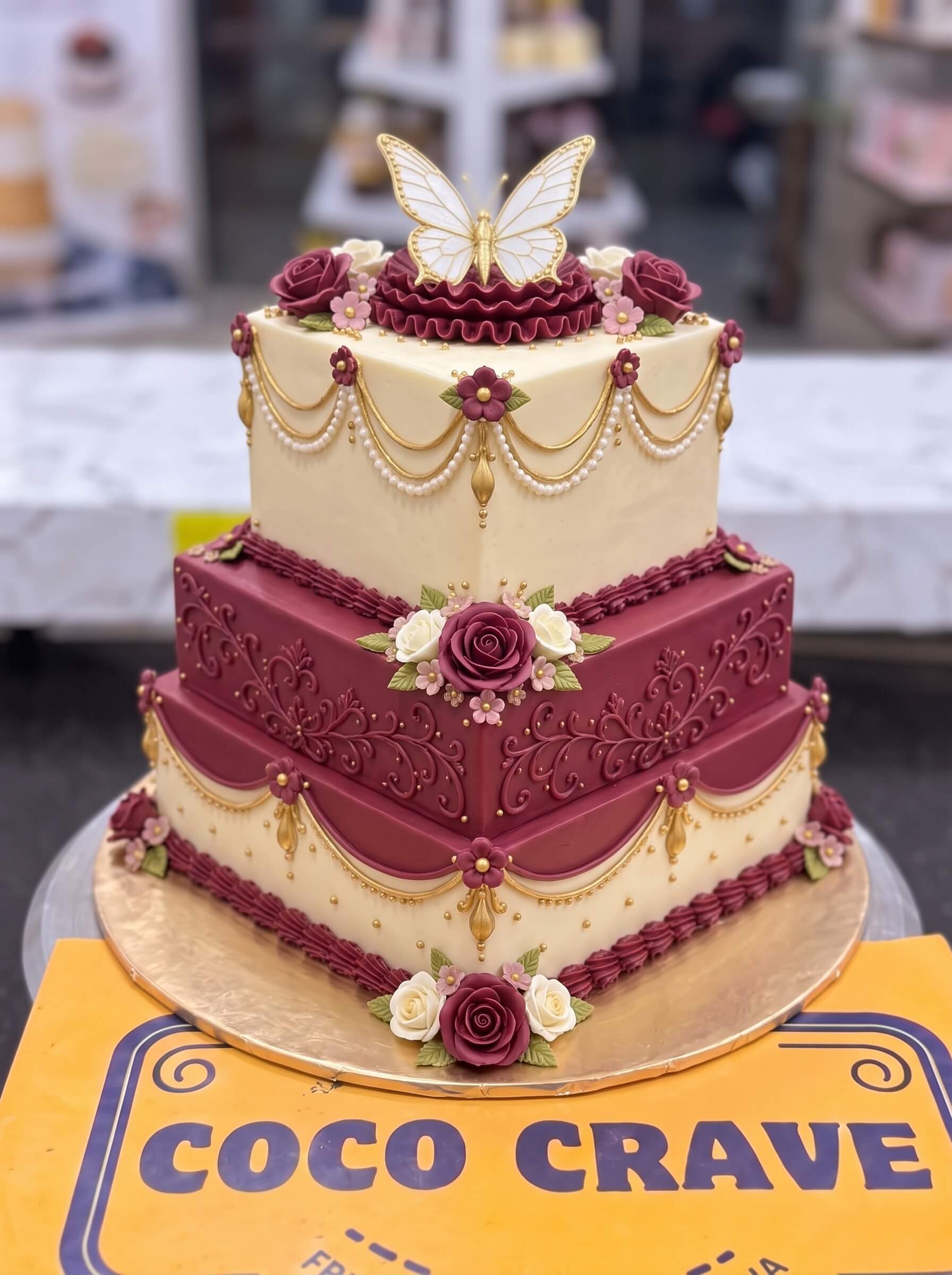 Maroon and Ivory Butterfly Wedding Cake in Lahore by CocoCrave.pk Maroon and Ivory Butterfly Wedding Cake in Lahore