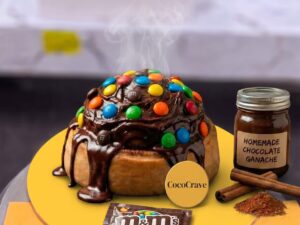 Chocolate and M&Ms Loaded Cinnamon Roll in Lahore by CocoCrave.pk