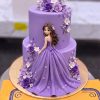 Lavender Princess Doll Cake in Lahore 2 Lavender Princess Doll Cake in Lahore — A two tier lavender cake with a princess doll standing against the side, her gown flowing down across both tie