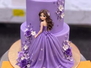 Lavender Princess Doll Cake in Lahore — A two tier lavender cake with a princess doll standing against the side, her gown flowing down across both tie