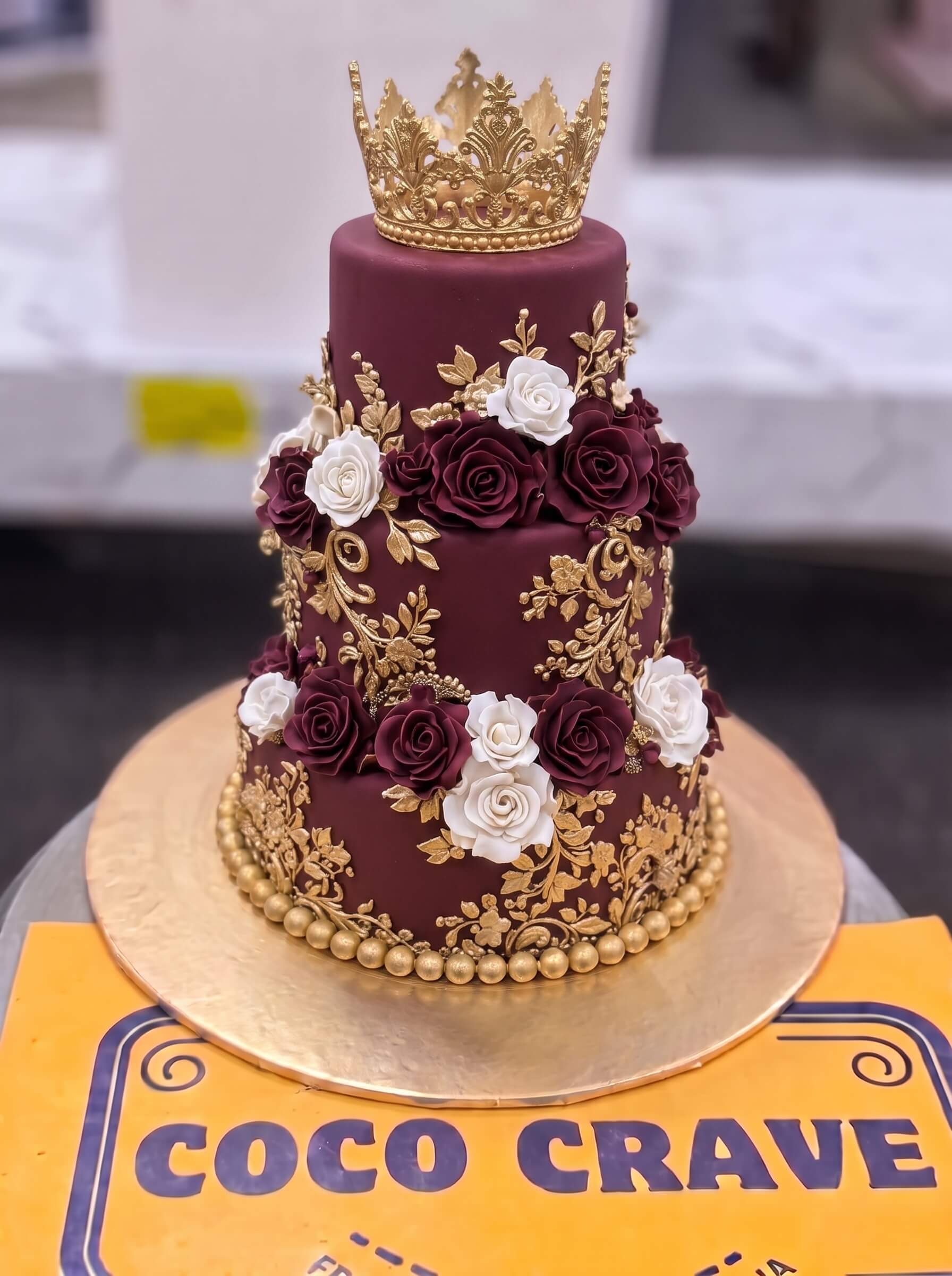 Edit_cake_images_2K_202609060422 Maroon Rose Two Tier Crown Cake in Lahore — Cococrave Lahore