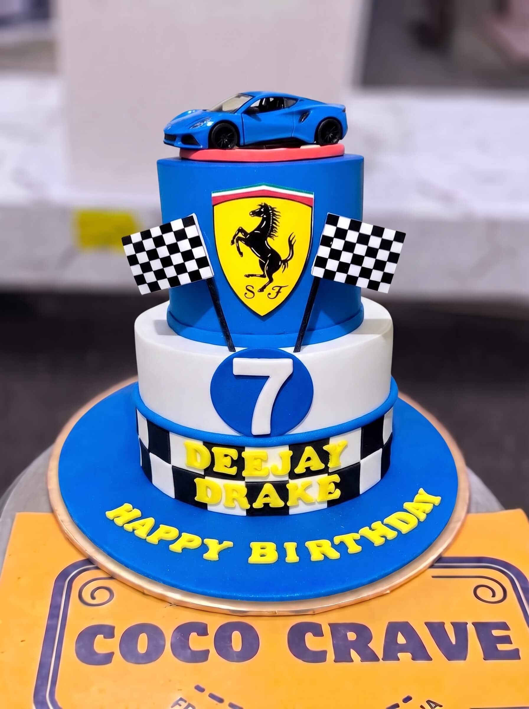 Ferrari Blue Race Cake in Lahore — CocoCrave.pk Ferrari Blue Race Cake in Lahore by CocoCrave.pk — two tier Ferrari racing cake in blue, yellow and black