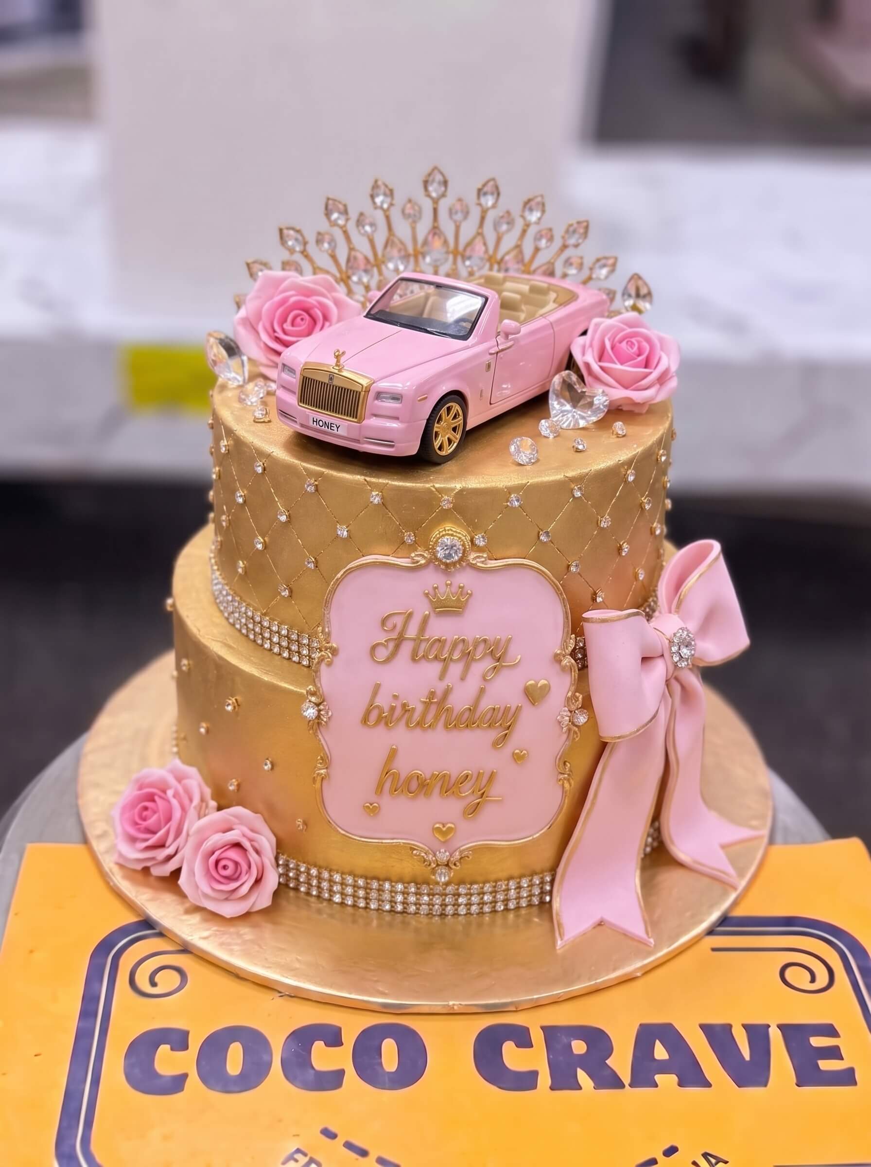 Edit_cake_placement_in_image_2K_202609060422 Gold Pink Car Crown Cake in Lahore — Cococrave Lahore