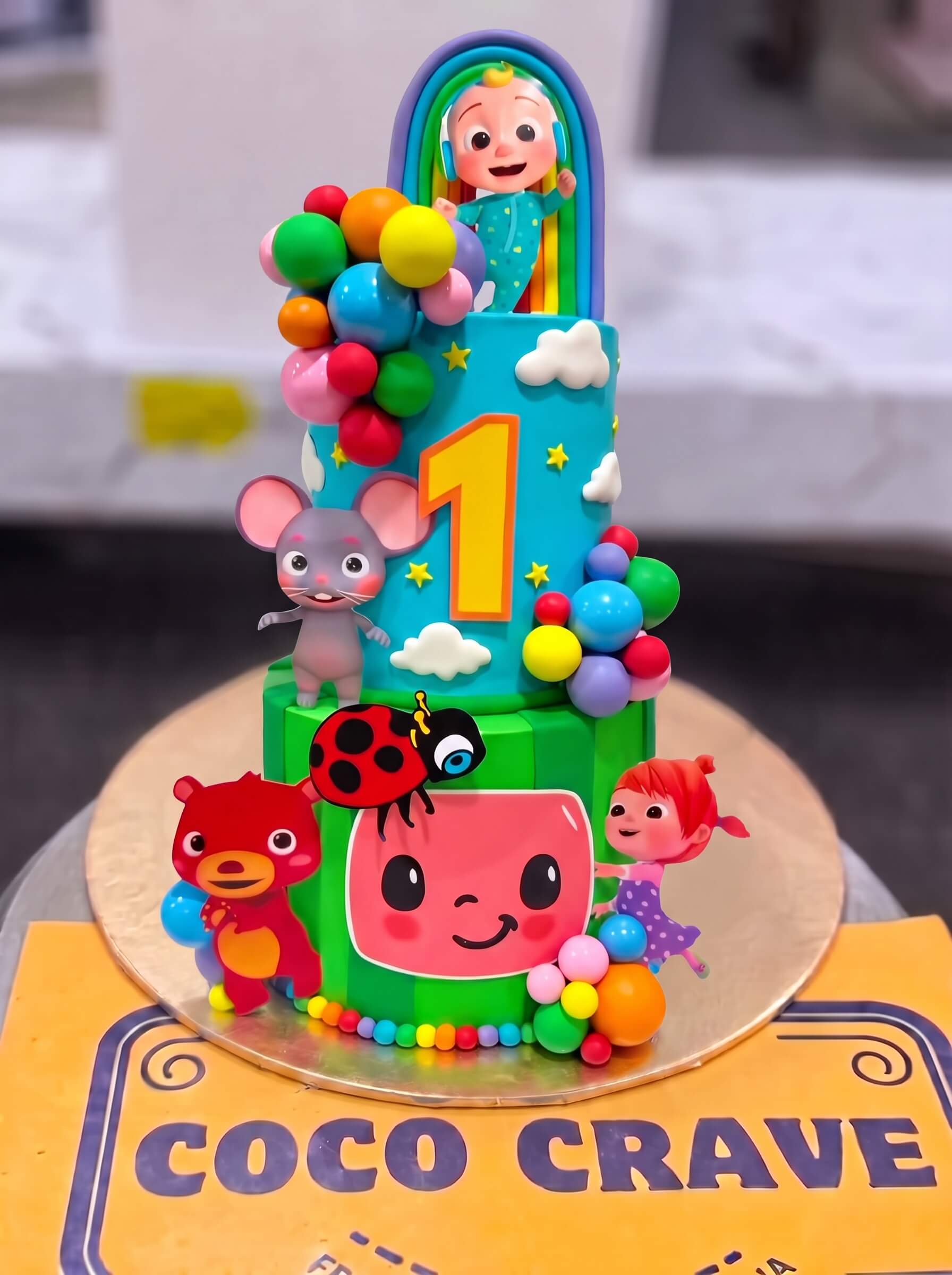 Cocomelon Balloon Arch Cake in Lahore — CocoCrave.pk Cocomelon Balloon Arch Cake in Lahore by CocoCrave.pk — three tier Cocomelon balloon arch cake in blue, green and red