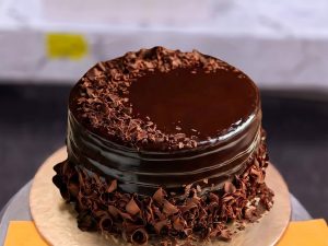 Dark Chocolate Shavings Cake in Lahore — A dark chocolate cake glazed on top and packed with hand-shaved chocolate flakes all around the sides — a rich