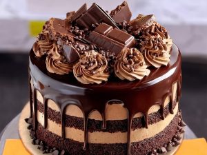 Chocolate Mousse Chunk Cake in Lahore — A layered chocolate mousse cake with a ganache drip, piped mousse swirls and real chocolate chunks on top — ou