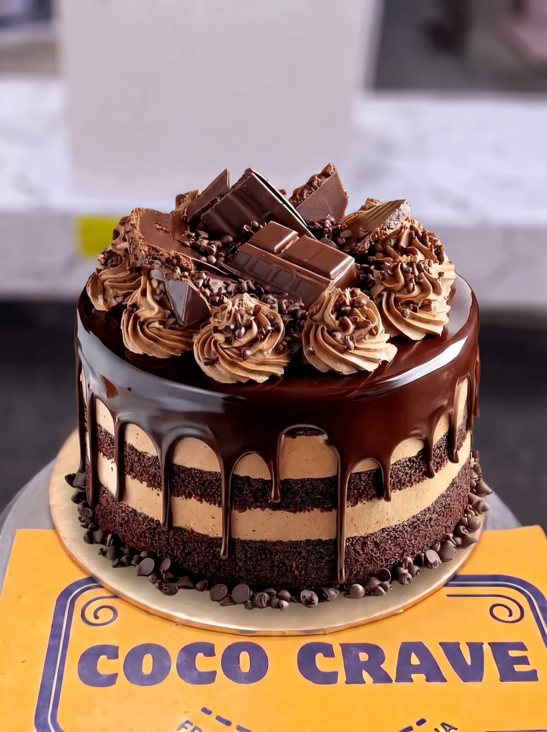 Chocolate Mousse Chunk Cake in Lahore — Coco Crave Lahore Chocolate Mousse Chunk Cake in Lahore — A layered chocolate mousse cake with a ganache drip, piped mousse swirls and real chocolate chunks on top — ou