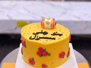Yellow Urdu Calligraphy Mayoun Cake in Lahore — A yellow mayoun cake with Urdu calligraphy hand-written across the fondant — a line of poetry, the couple's na