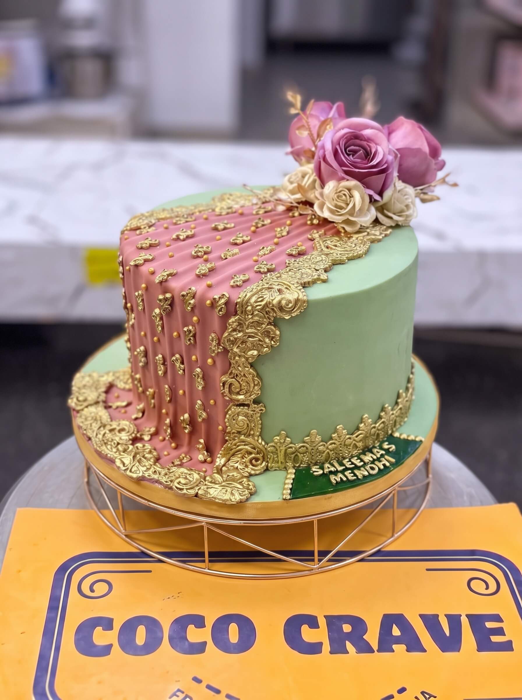 Pastel Green & Pink Floral Mehndi Cake in Lahore — Coco Crave Lahore Pastel Green & Pink Floral Mehndi Cake in Lahore — A pastel green mehndi cake scattered with piped pink blossoms — soft, garden-toned, and made for a daytime meh