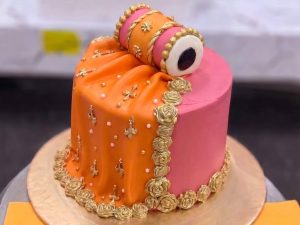 Orange & Pink Chooriyan Mehndi Cake in Lahore — Orange and pink sugar chooriyan stacked around a mehndi cake — bangles you can actually eat, in the two loudes