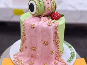 Pink & Green Dholki Mayoun Cake in Lahore — A pink and green dholki cake for the night the singing starts — bright, playful, and built around a hand-model