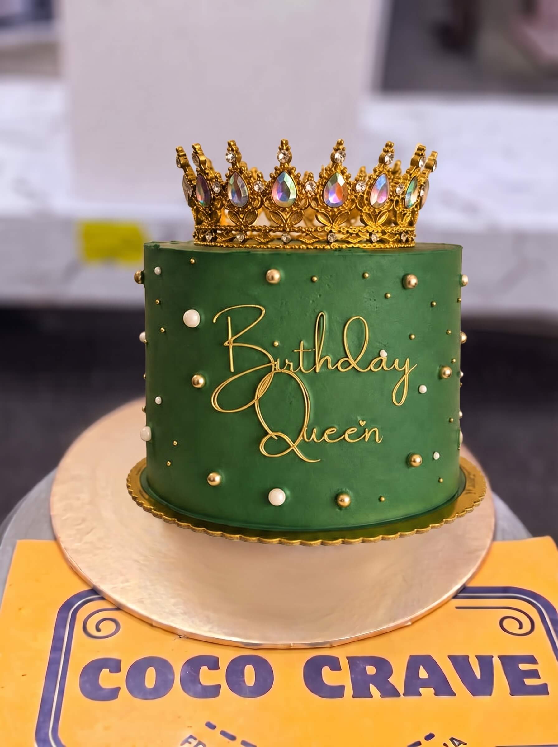 Move_cake_between_images_2K_202609060424 Emerald Birthday Queen Crown Cake in Lahore — Cococrave Lahore