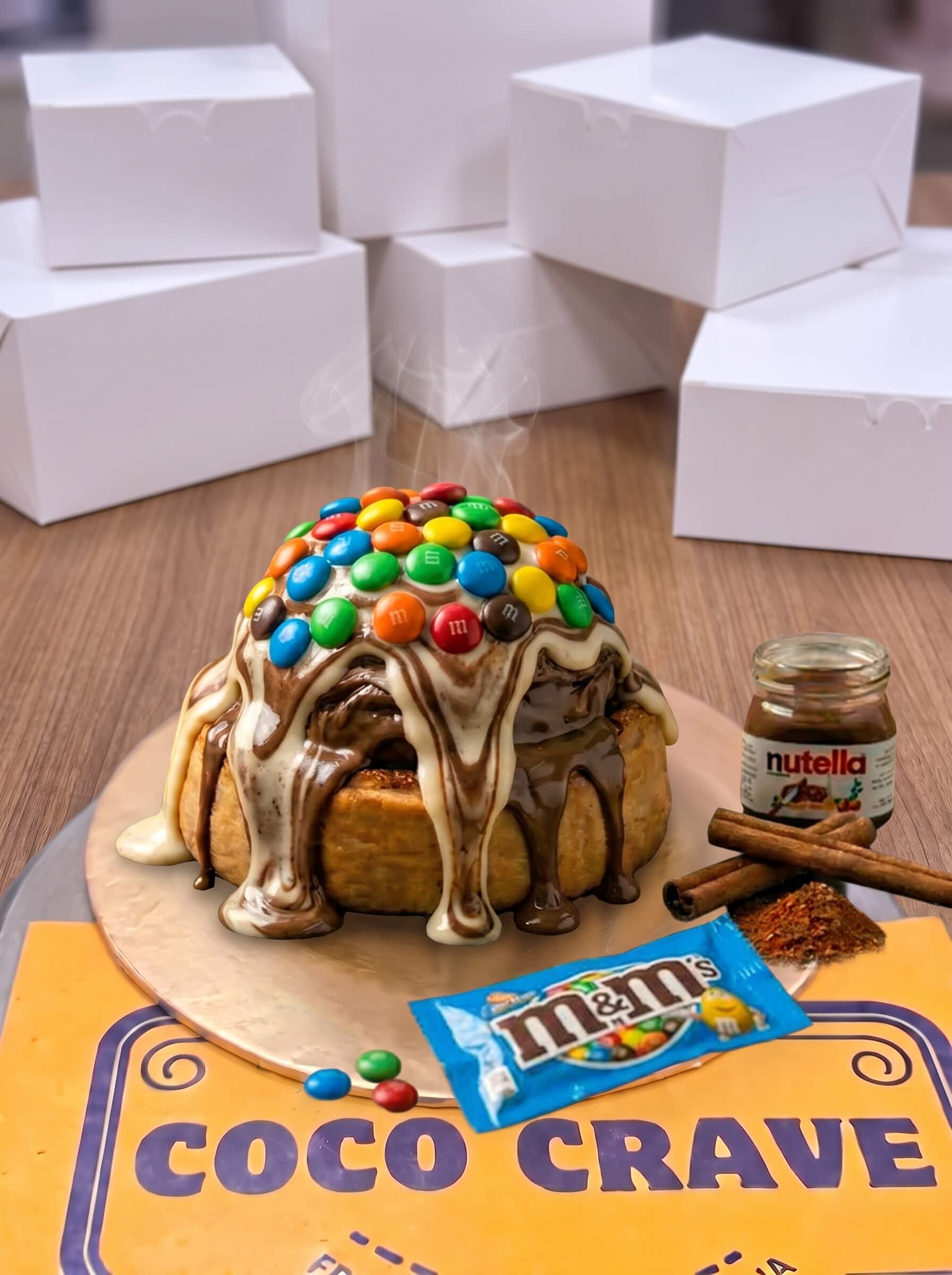 Triple Fusion Vanilla Nutella M&Ms Cinnamon Roll in Lahore | CocoCrave.pk Triple Fusion Vanilla Nutella M&Ms Cinnamon Roll in Lahore by CocoCrave.pk