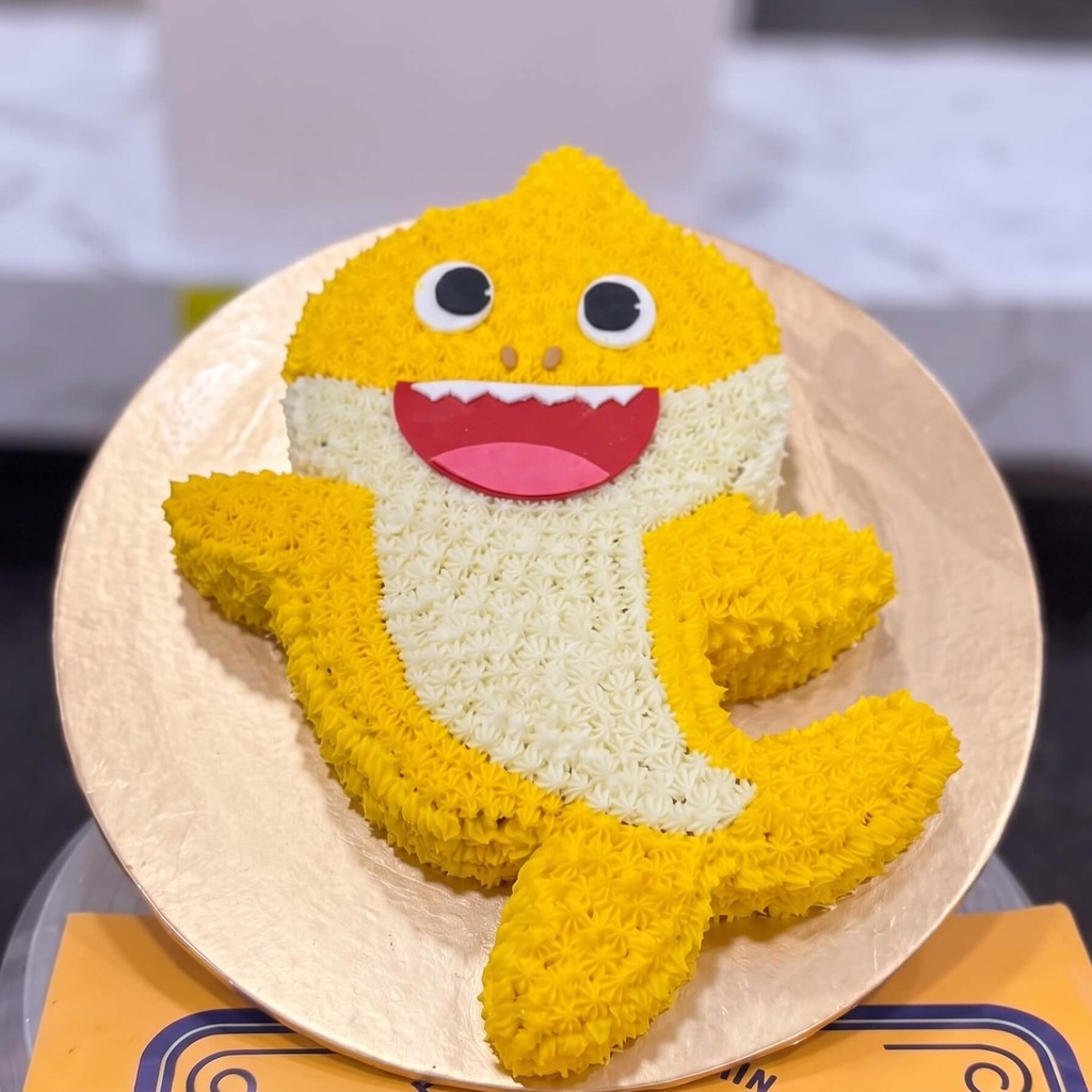 Baby Shark Shaped Birthday Cake in Lahore — CocoCrave.pk Baby Shark Shaped Birthday Cake in Lahore by CocoCrave.pk — single tier Baby Shark cake in Yellow