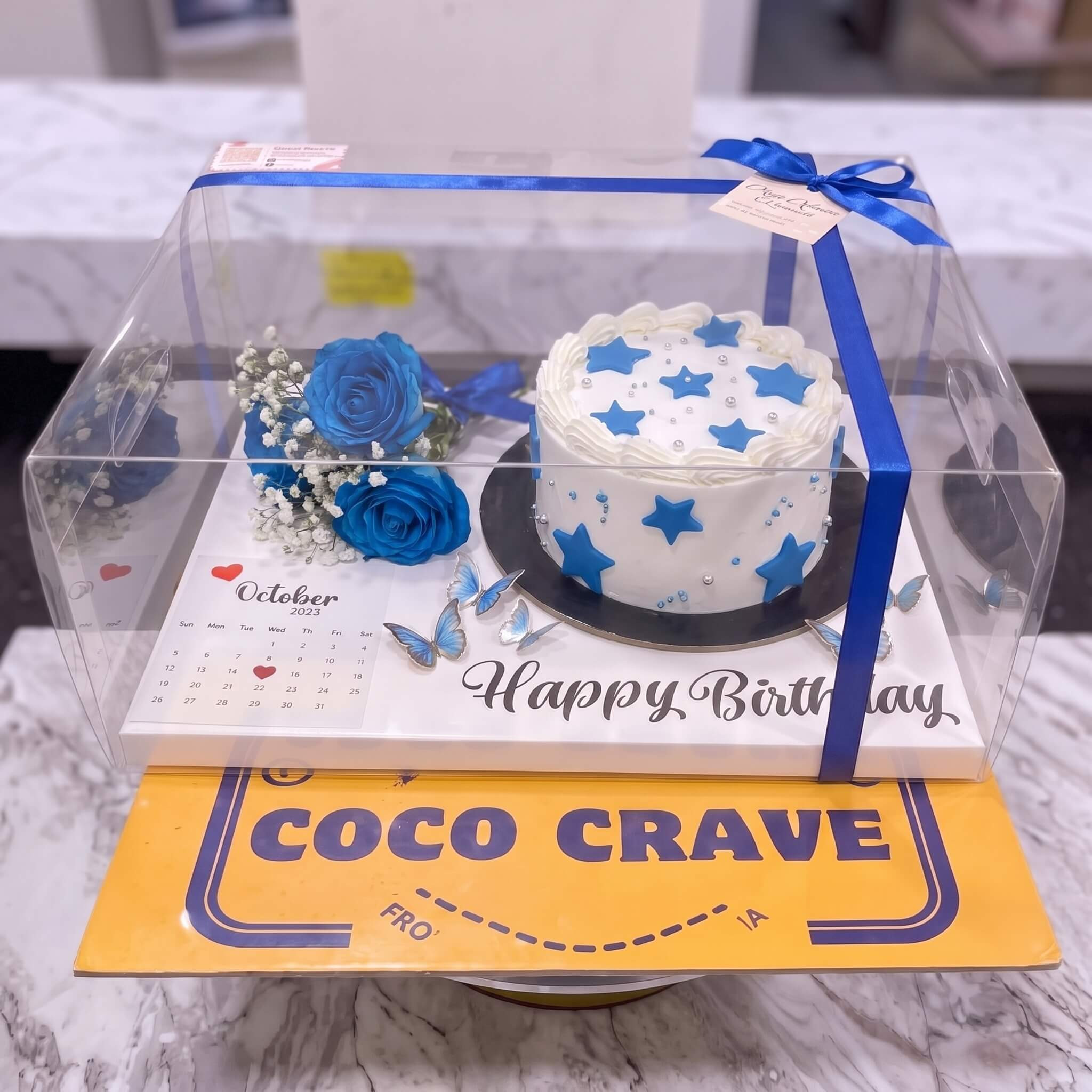 Blue Floral Birthday Cake in Clear Gift Box in Lahore Blue Floral Birthday Cake in Clear Gift Box in Lahore — CocoCrave Lahore