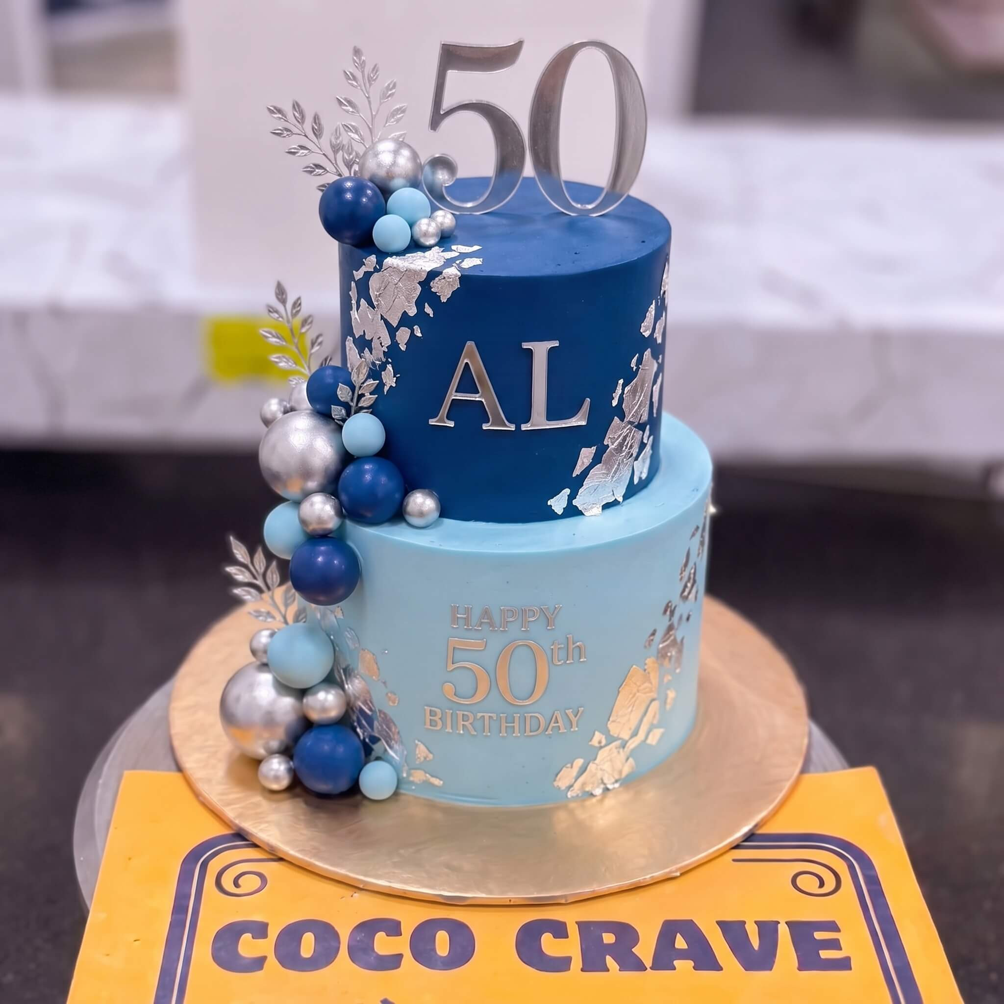 Blue Gold Fiftieth Birthday Celebration Cake in Lahore Blue Gold Fiftieth Birthday Celebration Cake in Lahore — CocoCrave Lahore