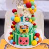 Cocomelon First Birthday Cake in Lahore by CocoCrave.pk — three tier Cocomelon first birthday cake in white, blue and green