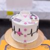 Doctor ECG Cake in Lahore 2 Doctor ECG Cake in Lahore by CocoCrave.pk — single tier doctor cake in white, black and pink