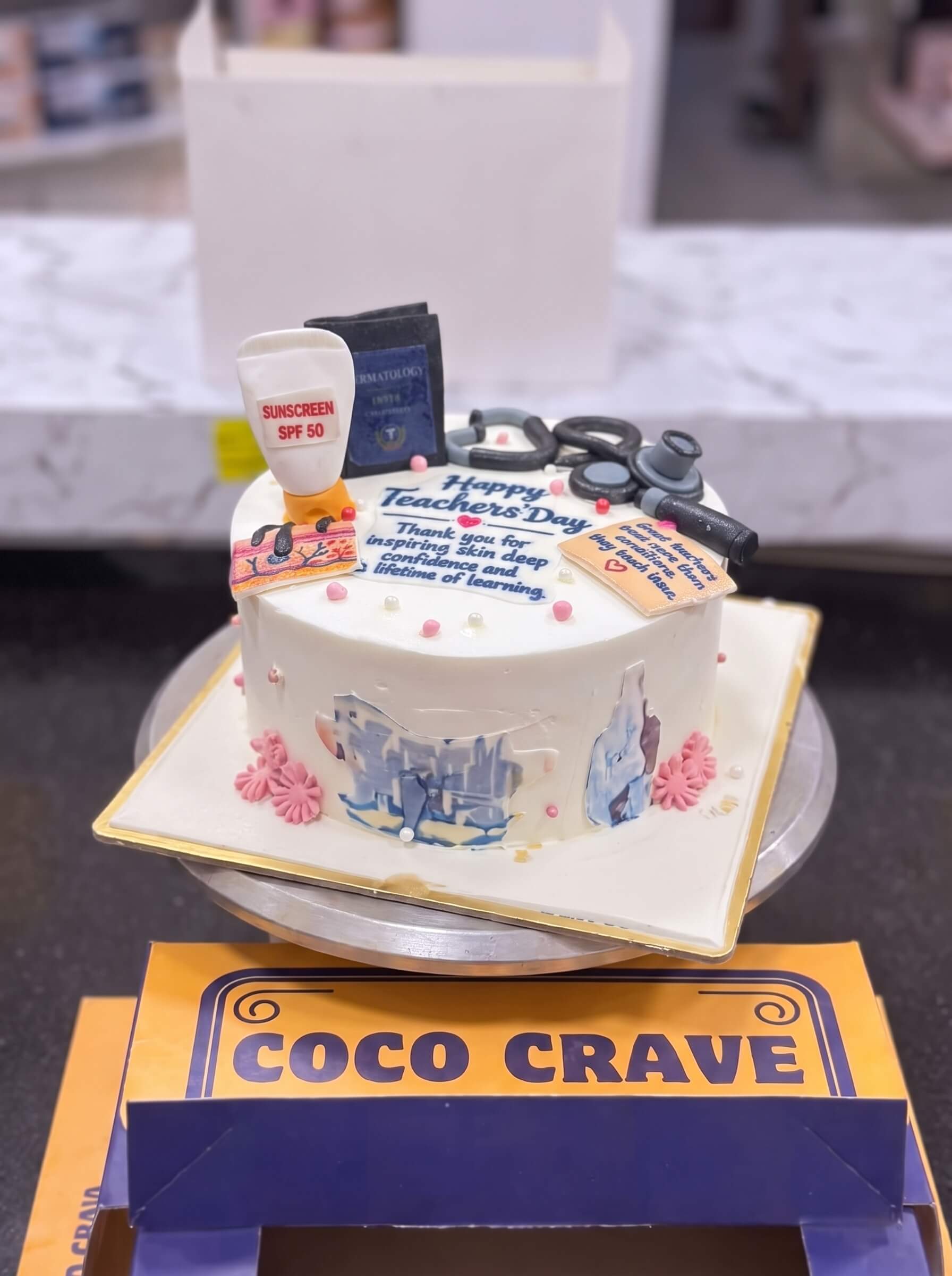 Medical Graduation Doctor Cake in Lahore — CocoCrave.pk Medical Graduation Doctor Cake in Lahore by CocoCrave.pk — single tier medical graduation cake in white and gold