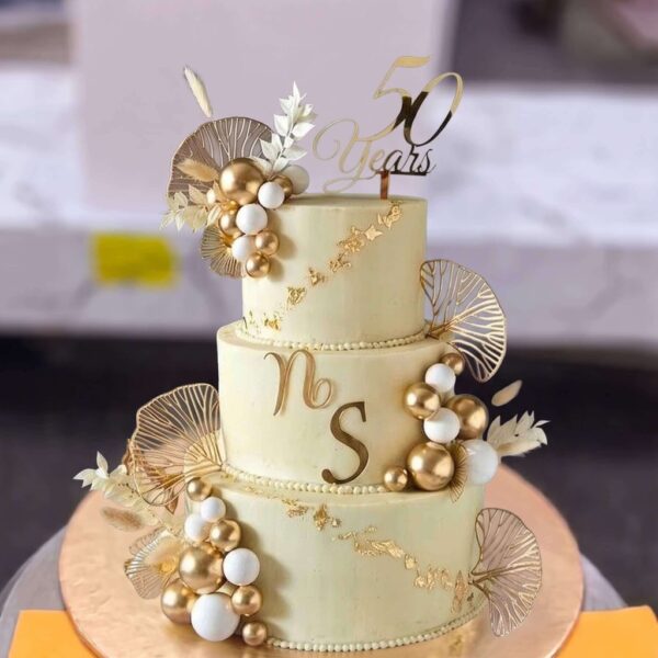 Ivory and Gold 50 Years Anniversary Cake in Lahore — delivered in Eme Society, Lahore