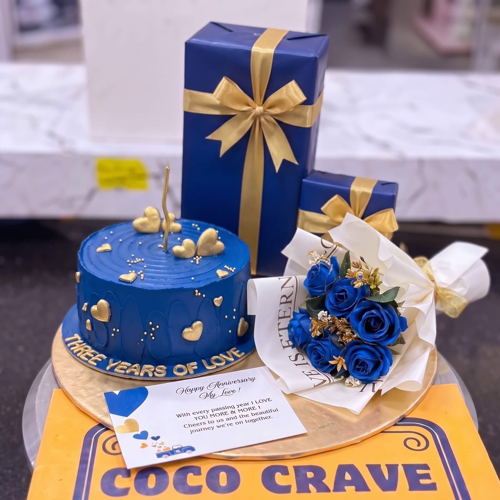 Navy Gold Birthday Cake with Gift Boxes in Lahore Navy Gold Birthday Cake with Gift Boxes in Lahore — CocoCrave Lahore