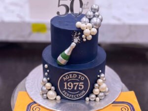 Navy Gold Fiftieth Birthday Champagne Cake in Lahore