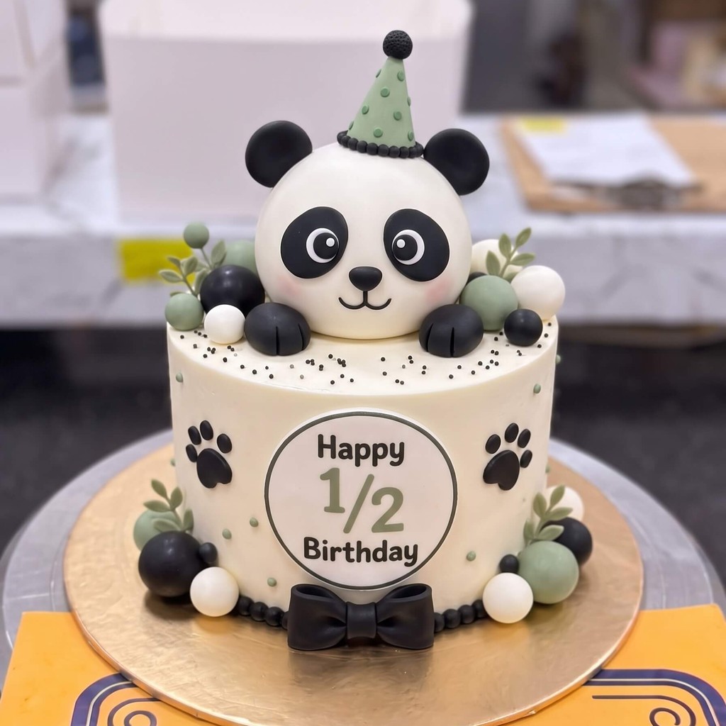 Panda Half Birthday Cake in Lahore — CocoCrave.pk Panda Half Birthday Cake in Lahore by CocoCrave.pk — single tier panda cake in White and Black