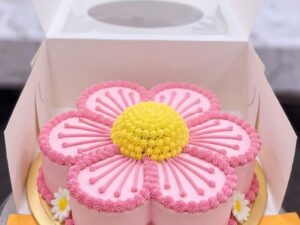 Pink Daisy Shaped Birthday Cake in Lahore — freshly baked cake delivered in Lahore by CocoCrave.pk