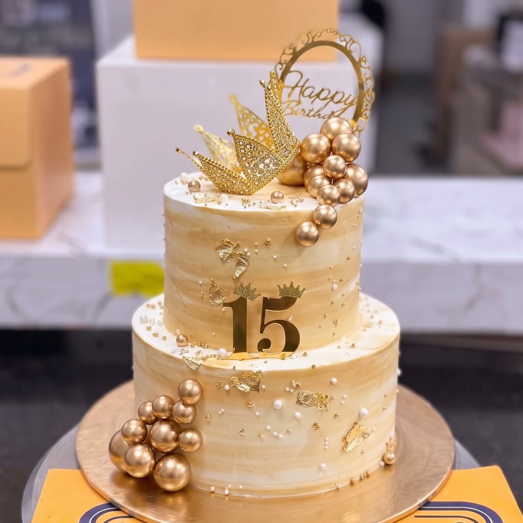 Two Tier Cream and Gold 15th Birthday Cake in Lahore Two Tier Cream and Gold 15th Birthday Cake by CocoCrave.pk in Lahore