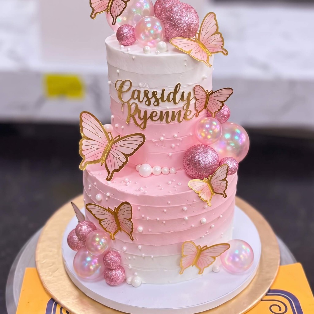 Two Tier Pink Butterfly Cake with Pearls in Lahore Two Tier Pink Butterfly Cake with Pearls by CocoCrave.pk in Lahore