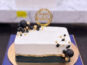 White and Black Cake with Gold Spheres in Lahore