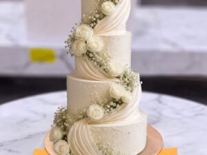 White Drape and Rose Four Tier Walima Cake in Lahore